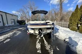 Slide: The Image of 2014 Monterey 204FS boat parked on snowy driveway, surrounded by trees and clear blue sky. - 3