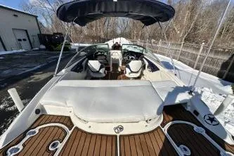 Slide: The Image of 2014 Monterey 204FS boat with spacious seating and sleek design, docked outdoors. - 4