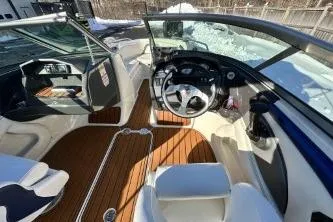 Slide: The Image of 2014 Monterey 204FS boat interior with steering wheel and wooden flooring. - 5