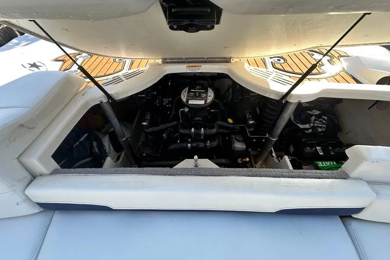 Slide: The Image of 2014 Monterey 204FS boat engine compartment with open hatch, showcasing internal components. - 9