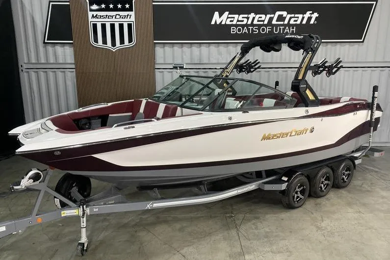 The Image of 2023 MasterCraft X26 boat on trailer at MasterCraft Boats of Utah showroom. - 1