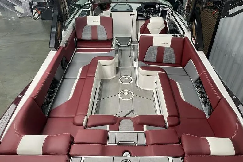 Slide: The Image of 2023 MasterCraft X26 boat interior with red and white seating, spacious layout. - 6