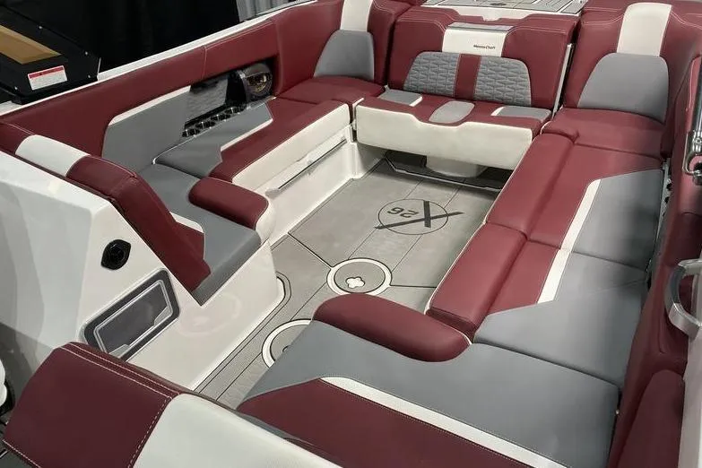 Slide: The Image of 2023 MasterCraft X26 boat interior with red and gray seating, modern design. - 8