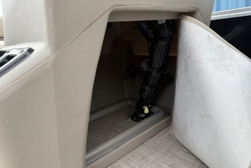 Slide: The Image of 2024 Sun Tracker Party Barge 16 DLX interior compartment with wiring visible. - 10