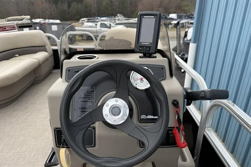 Slide: The Image of 2024 Sun Tracker Party Barge 16 DLX steering console with GPS and RPM gauge. - 12