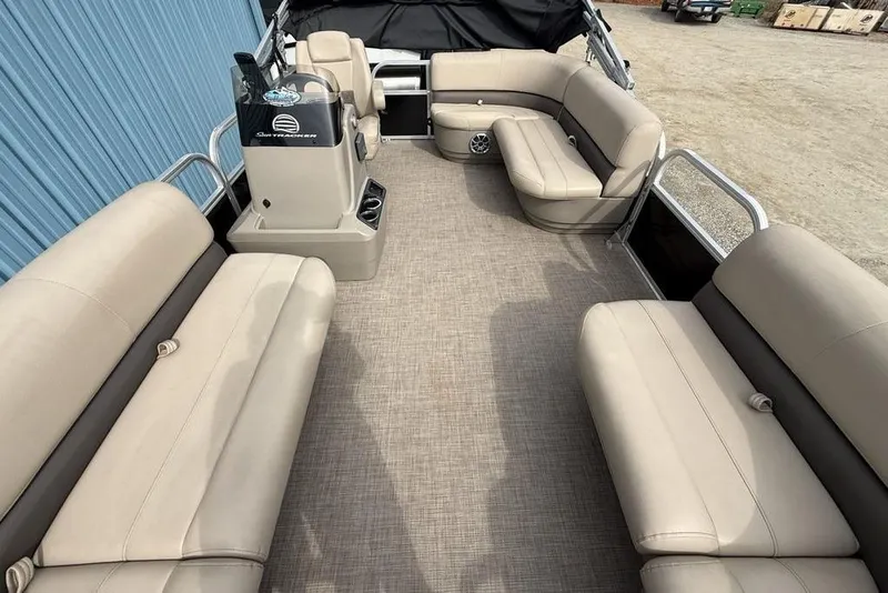 Slide: The Image of 2024 Sun Tracker Party Barge 16 DLX interior with beige seating and spacious layout. - 21