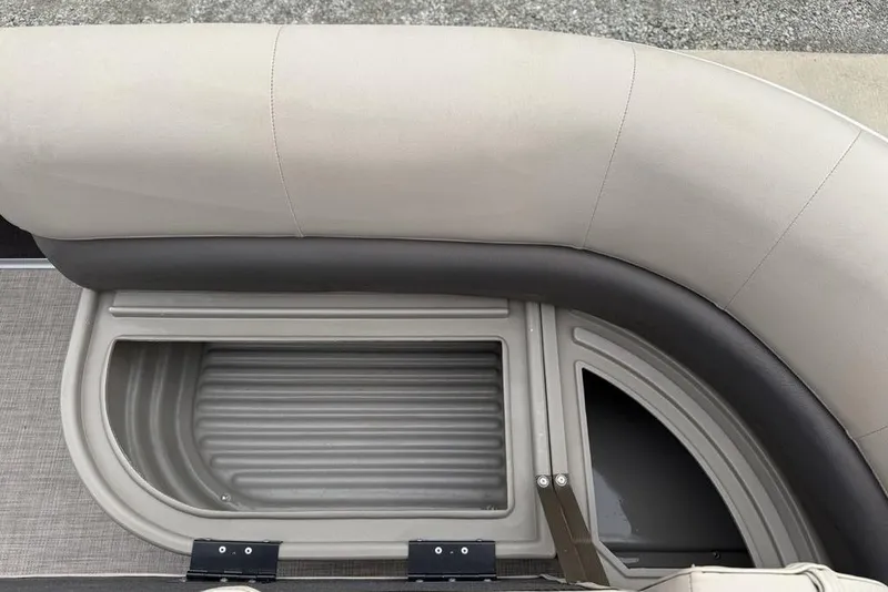 Slide: The Image of 2024 Sun Tracker Party Barge 16 DLX seating with storage compartment, beige upholstery. - 3