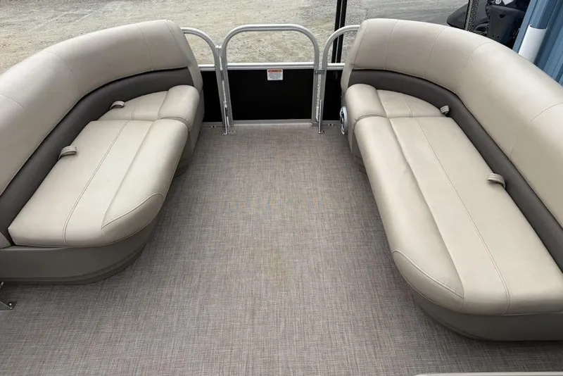 Slide: The Image of 2024 Sun Tracker Party Barge 16 DLX interior with beige seating and spacious layout. - 4
