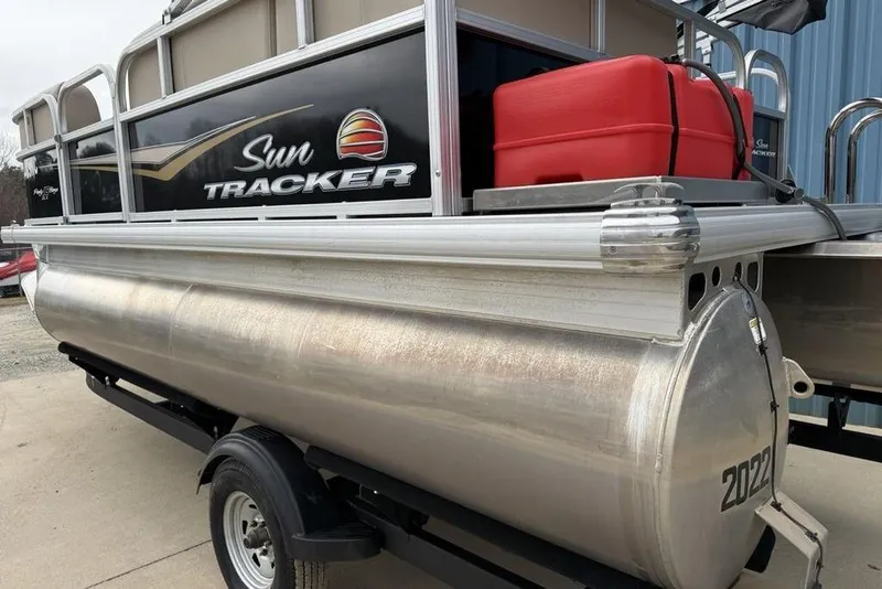 Slide: The Image of 2024 Sun Tracker Party Barge 16 DLX pontoon boat with red fuel tank on trailer. - 7