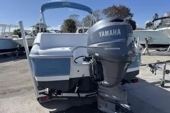 Slide: The Image of 2012 NauticStar 210DC Sport Deck boat with Yamaha outboard motor, parked on a trailer. - 3