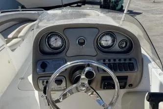 Slide: The Image of 2012 NauticStar 210DC Sport Deck boat dashboard with steering wheel and gauges. - 5