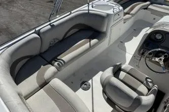 Slide: The Image of 2012 NauticStar 210DC Sport Deck boat interior with seating and steering wheel. - 6