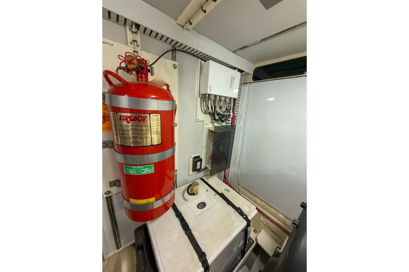 Slide: The Image of Engine room of 2007 Nordic Tug 54 with fire extinguisher and electrical panel. - 53