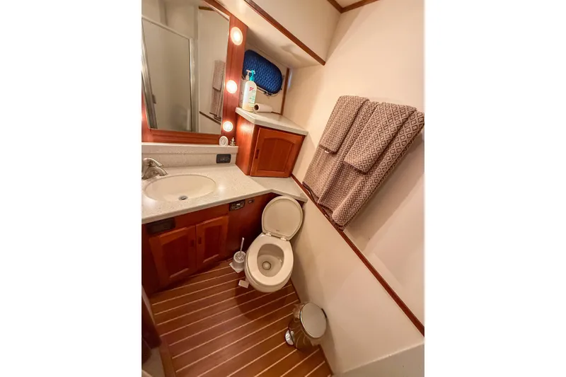 Slide: The Image of Luxurious bathroom in 2007 Nordic Tug 54 yacht with wooden flooring and modern fixtures. - 56