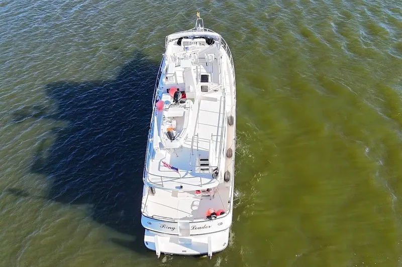 Slide: The Image of Nordic Tug 54 (2007) cruising on calm green waters, aerial view. - 9