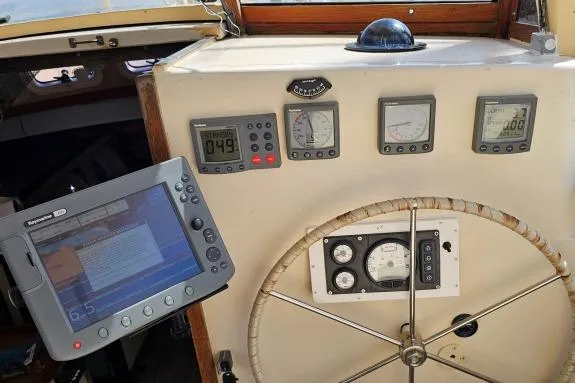 Slide: The Image of Control panel of 2002 Parker Marine Lorcha 50 with navigation instruments and steering wheel. - 14