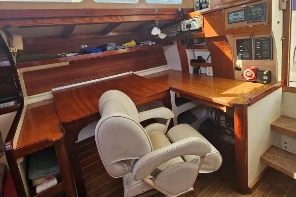 Slide: The Image of Interior of 2002 Parker Marine Lorcha 50, featuring a wooden desk and comfortable chair. - 4