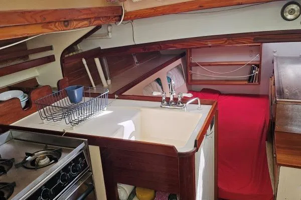 Slide: The Image of Interior of 2002 Parker Marine Lorcha 50 sailboat with kitchen and cozy sleeping area. - 6