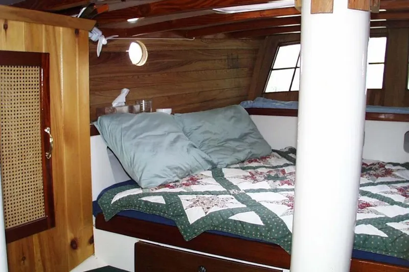 Slide: The Image of Cozy cabin interior of 2002 Parker Marine Lorcha 50 with quilted bedding and wooden accents. - 8