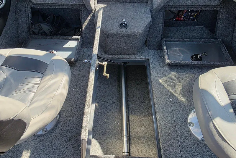 Slide: The Image of 2019 Tracker Targa V-18 WT interior with storage compartments and seating. - 11