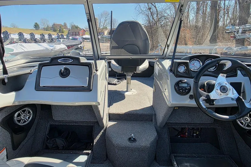 Slide: The Image of 2019 Tracker Targa V-18 WT boat interior with steering wheel and dashboard controls. - 12