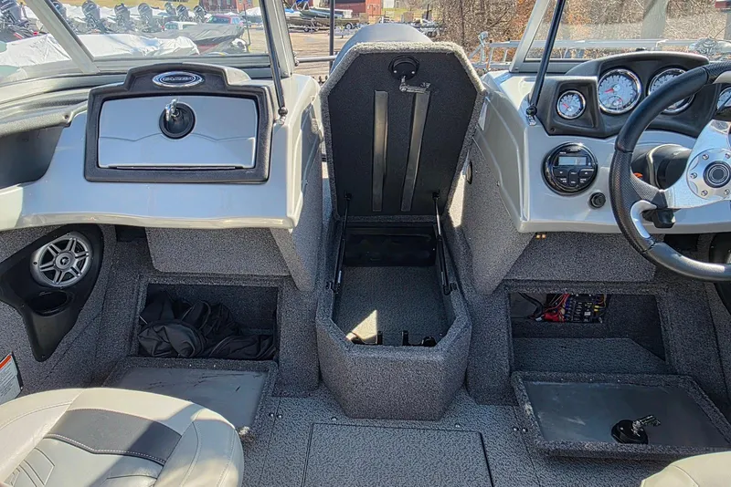 Slide: The Image of 2019 Tracker Targa V-18 WT boat interior with dashboard, steering wheel, and storage compartments. - 13