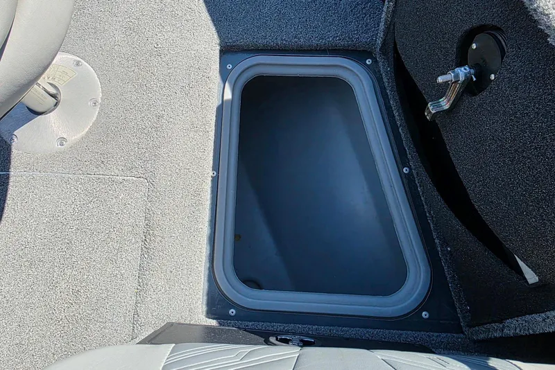 Slide: The Image of 2019 Tracker Targa V-18 WT boat storage compartment with gray interior. - 15