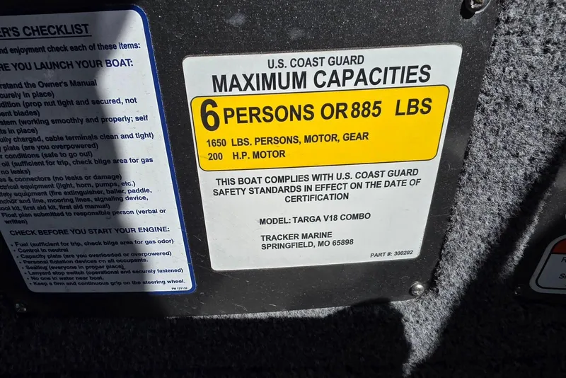 Slide: The Image of 2019 Tracker Targa V-18 WT capacity label, 6 persons or 885 lbs, U.S. Coast Guard compliant. - 24