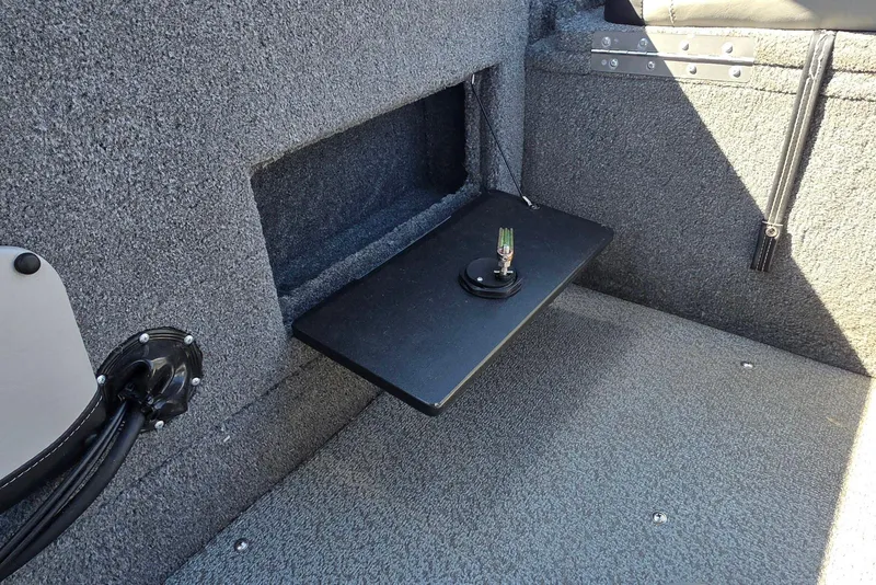 Slide: The Image of 2019 Tracker Targa V-18 WT interior with storage compartment and mounted accessory. - 26