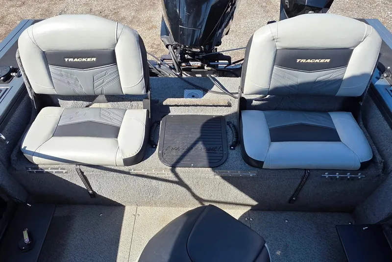 Slide: The Image of 2019 Tracker Targa V-18 WT boat interior with two gray seats and motor. - 27