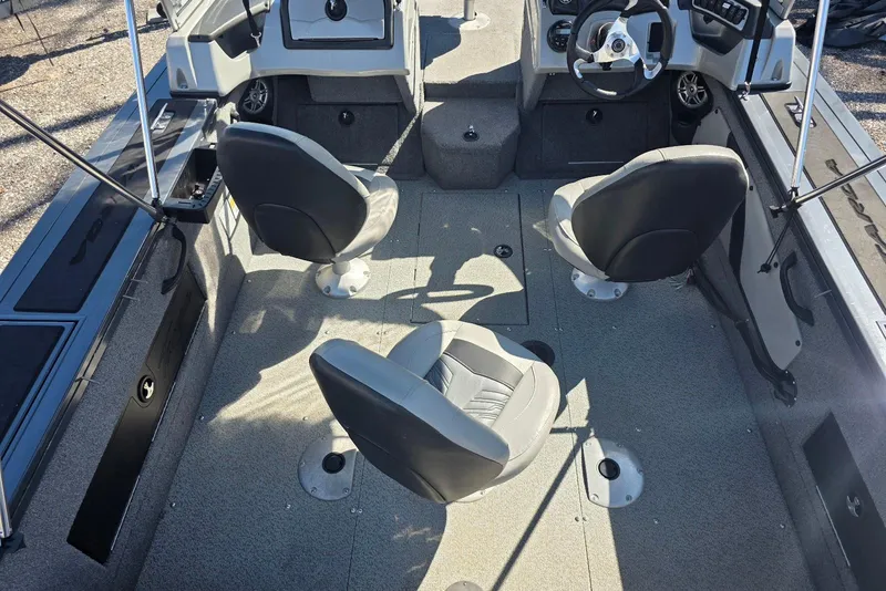 Slide: The Image of 2019 Tracker Targa V-18 WT boat interior with three swivel seats and steering console. - 9