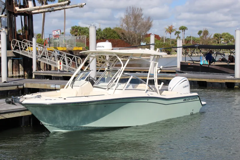 The Image of 2023 Grady-White Freedom 235 boat docked in a marina, featuring Yamaha engine. - 0