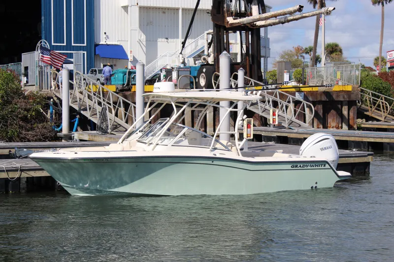 Slide: The Image of 2023 Grady-White Freedom 235 boat docked at marina with Yamaha engine. - 1