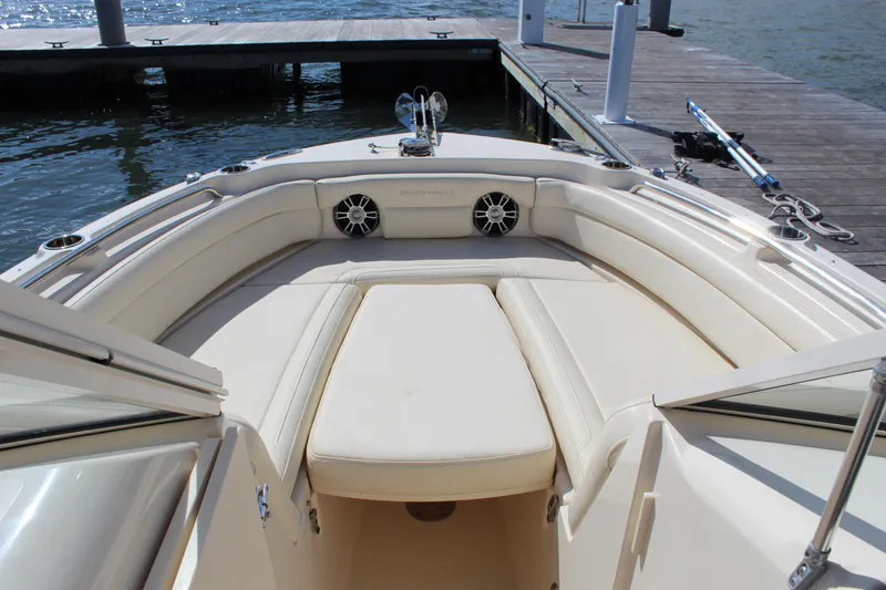 Slide: The Image of 2023 Grady-White Freedom 235 boat interior with Garmin navigation system, docked by the water. - 12