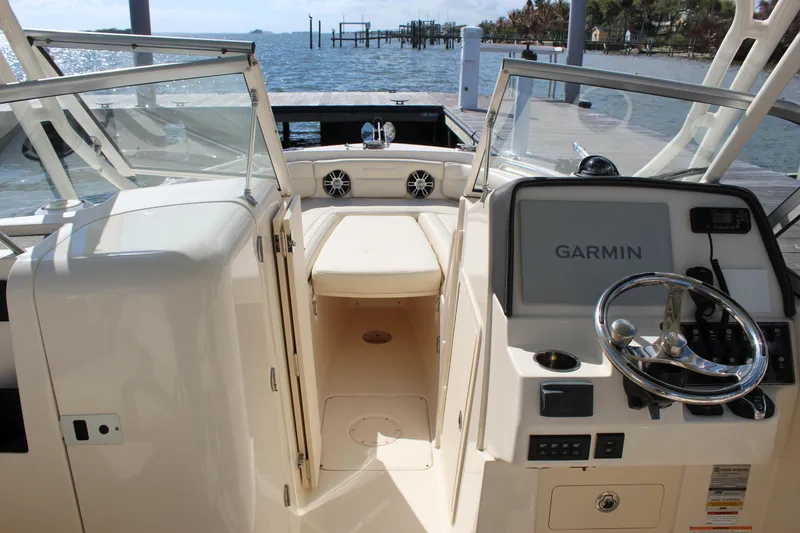 Slide: The Image of 2023 Grady-White Freedom 235 boat dashboard with Garmin navigation system. - 13