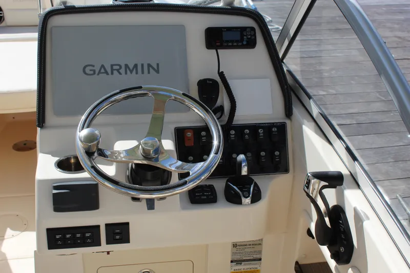 Slide: The Image of 2023 Grady-White Freedom 235 boat helm with Garmin navigation system and controls. - 14