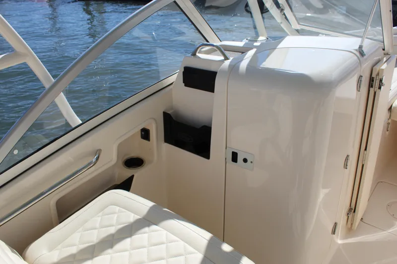 Slide: The Image of 2023 Grady-White Freedom 235 boat interior with cushioned seating and water view. - 16