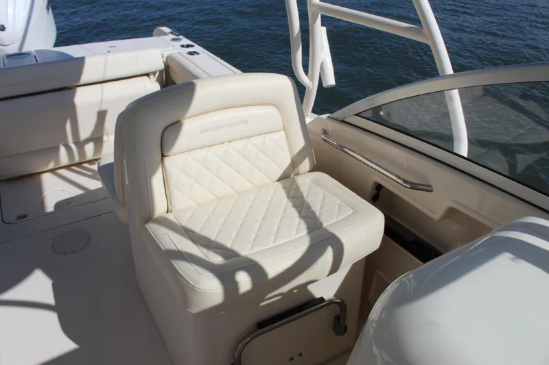 Slide: The Image of 2023 Grady-White Freedom 235 boat interior with helm seat and steering wheel. - 17