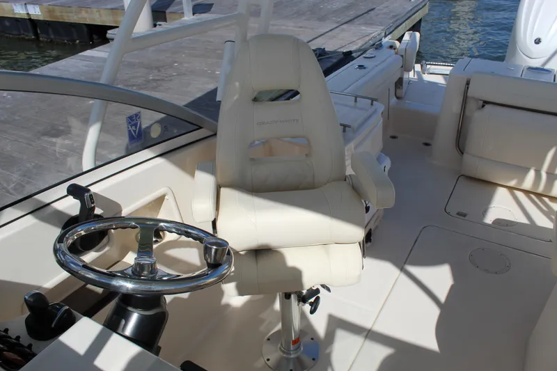 Slide: The Image of 2023 Grady-White Freedom 235 boat interior with cushioned seating and water view. - 18