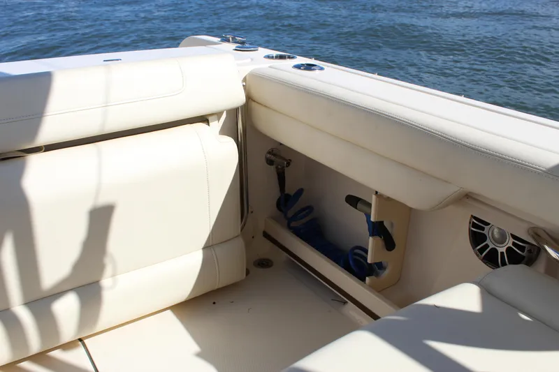 Slide: The Image of 2023 Grady-White Freedom 235 boat interior at marina, featuring comfortable seating and open deck. - 20
