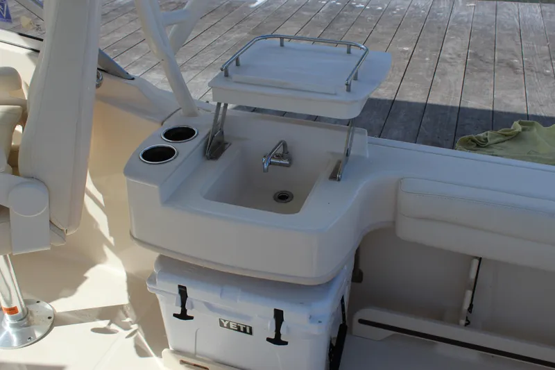 Slide: The Image of 2023 Grady-White Freedom 235 boat interior with sink and seating area. - 27