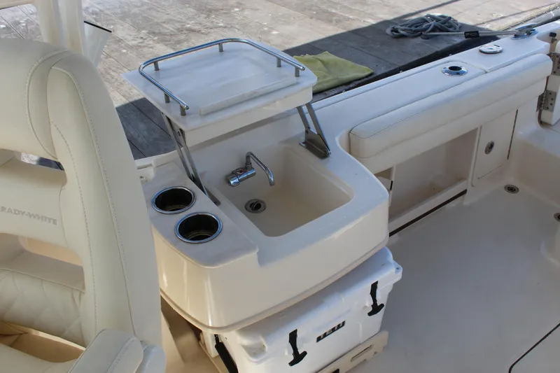 Slide: The Image of 2023 Grady-White Freedom 235 boat ladder and engine near dock. - 28