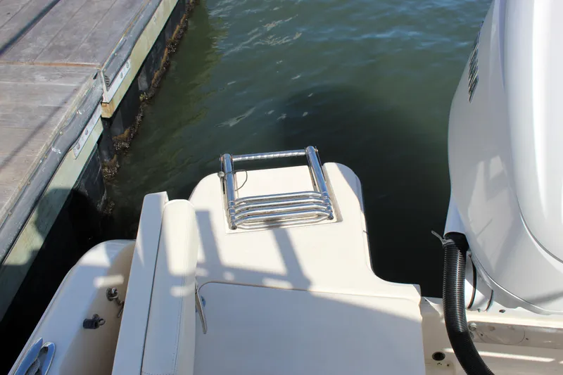 Slide: The Image of 2023 Grady-White Freedom 235 boat with open storage compartment and cushioned seating. - 29