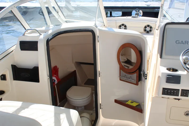 Slide: The Image of 2023 Grady-White Freedom 235 boat docked by the water on a sunny day. - 32