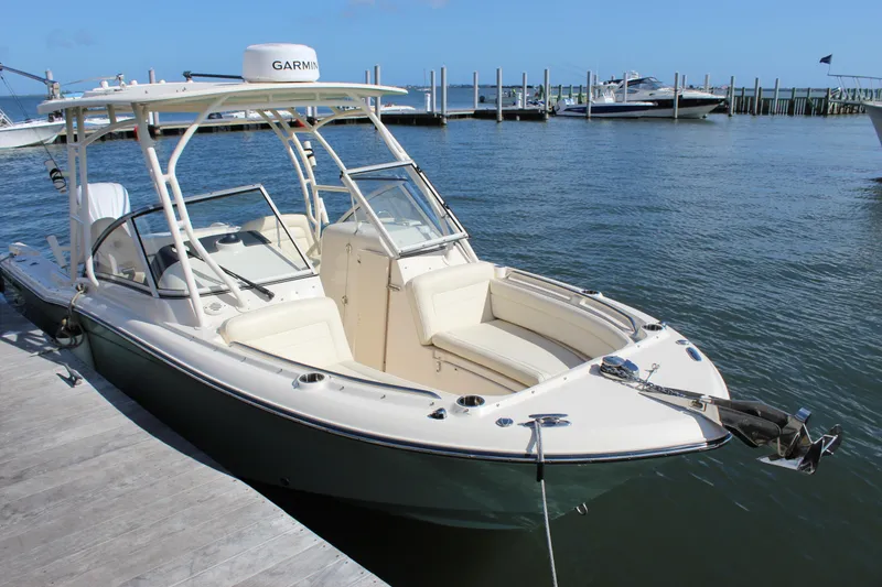 Slide: The Image of 2023 Grady-White Freedom 235 boat interior with cushioned seating by the water. - 4