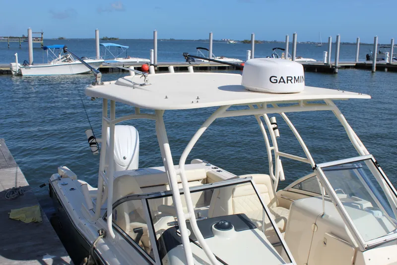 Slide: The Image of 2023 Grady-White Freedom 235 boat docked by the water on a sunny day. - 8