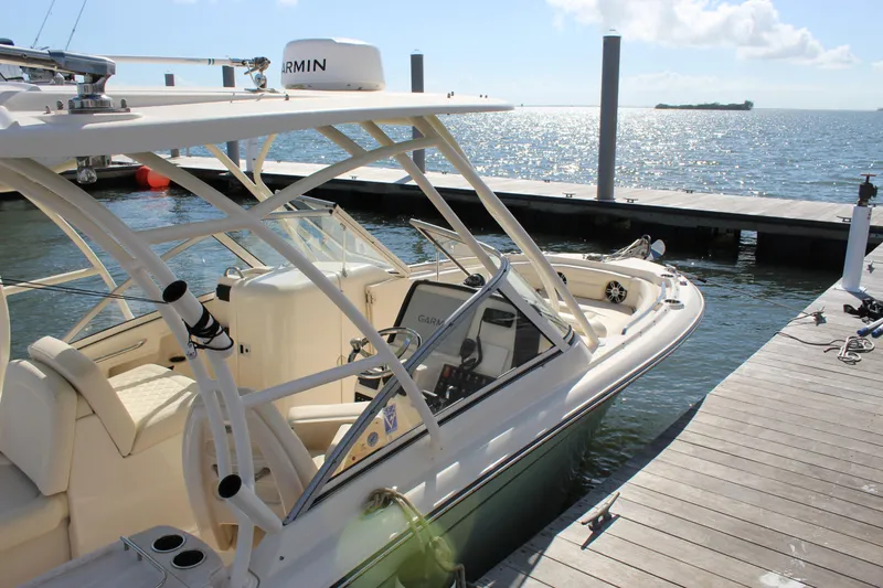 Slide: The Image of 2023 Grady-White Freedom 235 boat with Yamaha V6 engine docked on water. - 9