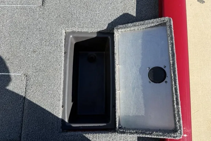 Slide: The Image of Open storage compartment on 2022 Tracker Pro Team 175 TXW Tournament Edition boat. - 25