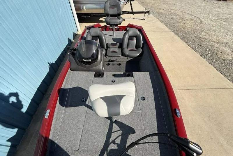 Slide: The Image of 2022 Tracker Pro Team 175 TXW Tournament Edition boat with seating and motor, docked outdoors. - 28