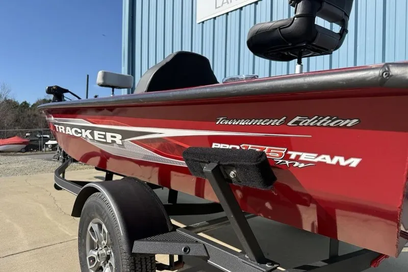 Slide: The Image of 2022 Tracker Pro Team 175 TXW Tournament Edition boat, red exterior, parked on trailer. - 7